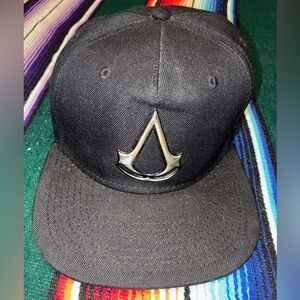 Assassin’s Creed Black Snapback Hat Metal Logo Ubisoft One Size